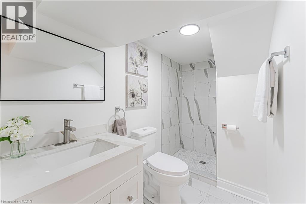 Full bathroom with spacious vanity, separate shower & ready for you! - 15 Barnesdale Avenue N, Hamilton, ON - Indoor Photo Showing Bathroom