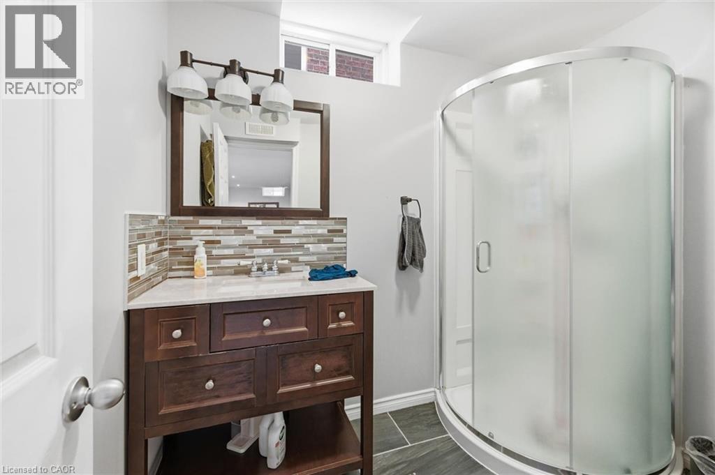 Bathroom with vanity, a shower stall, and decorative backsplash - 456 Valridge Drive, Ancaster, ON - Indoor Photo Showing Bathroom