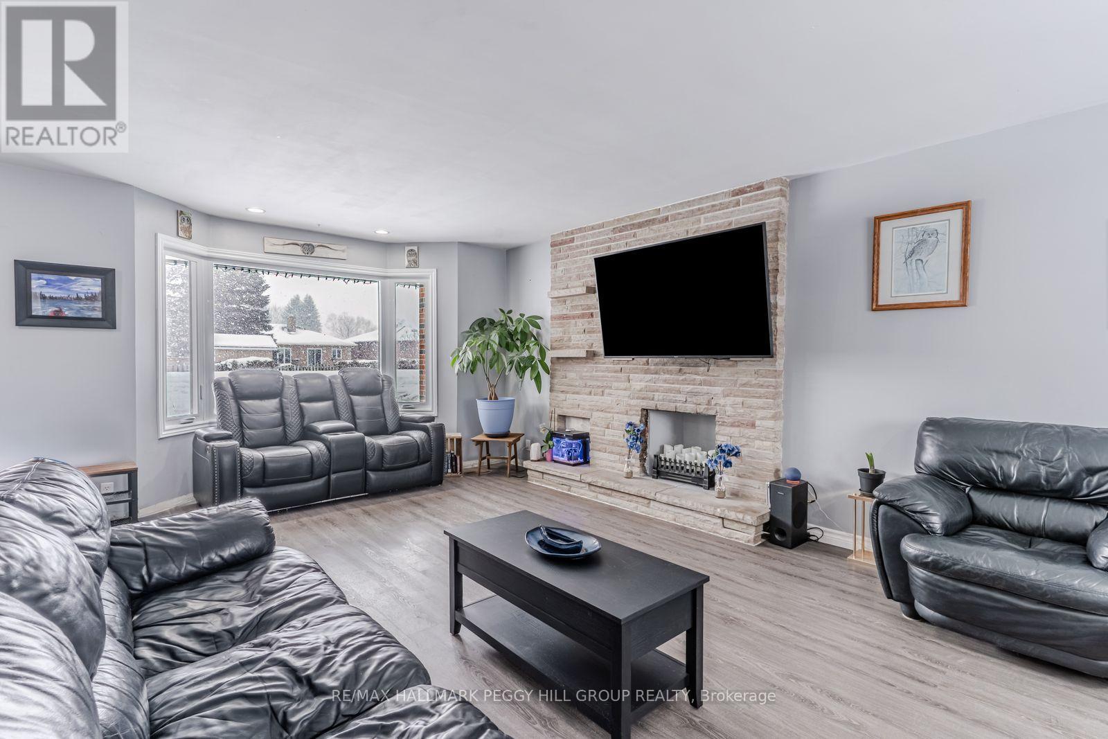 90 Queen Street E, Springwater, ON - Indoor Photo Showing Living Room With Fireplace