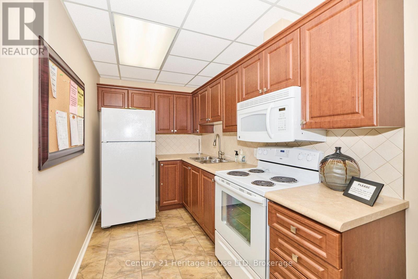 Party Room Kitchen - 504 - 81 Scott Street, St. Catharines (Lakeport), ON - Indoor Photo Showing Kitchen With Double Sink