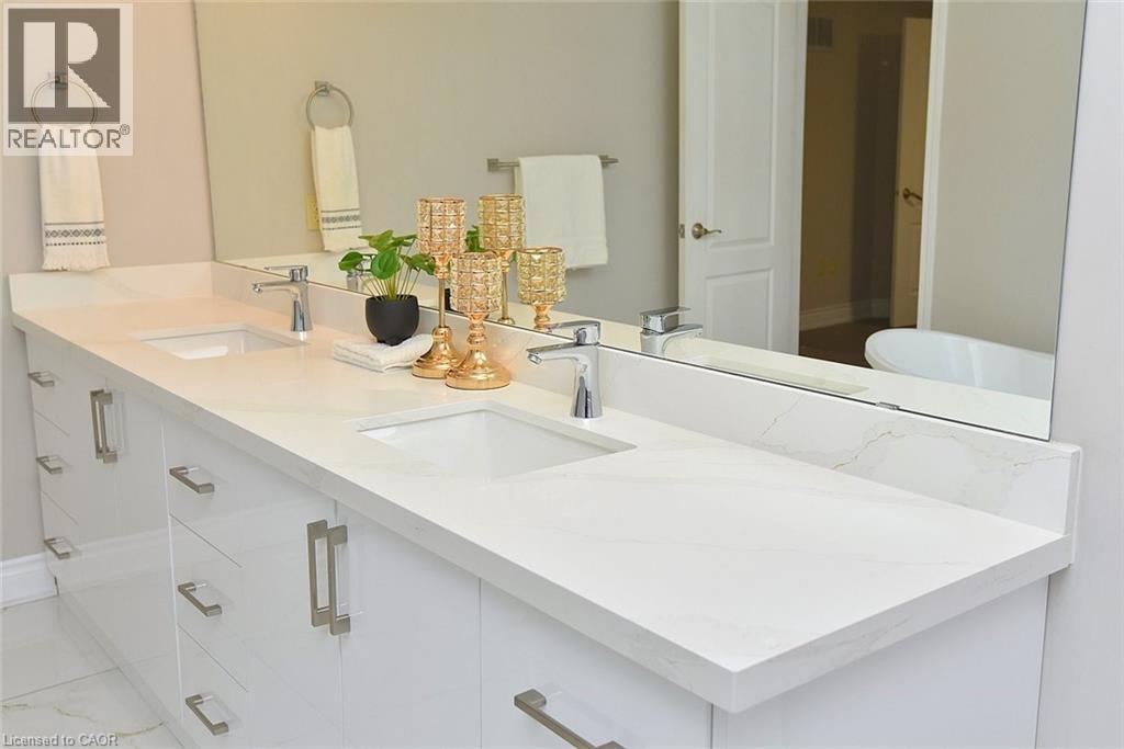 Full bathroom with double vanity and baseboards - 5109 Blue Spruce Avenue, Burlington, ON - Indoor Photo Showing Bathroom