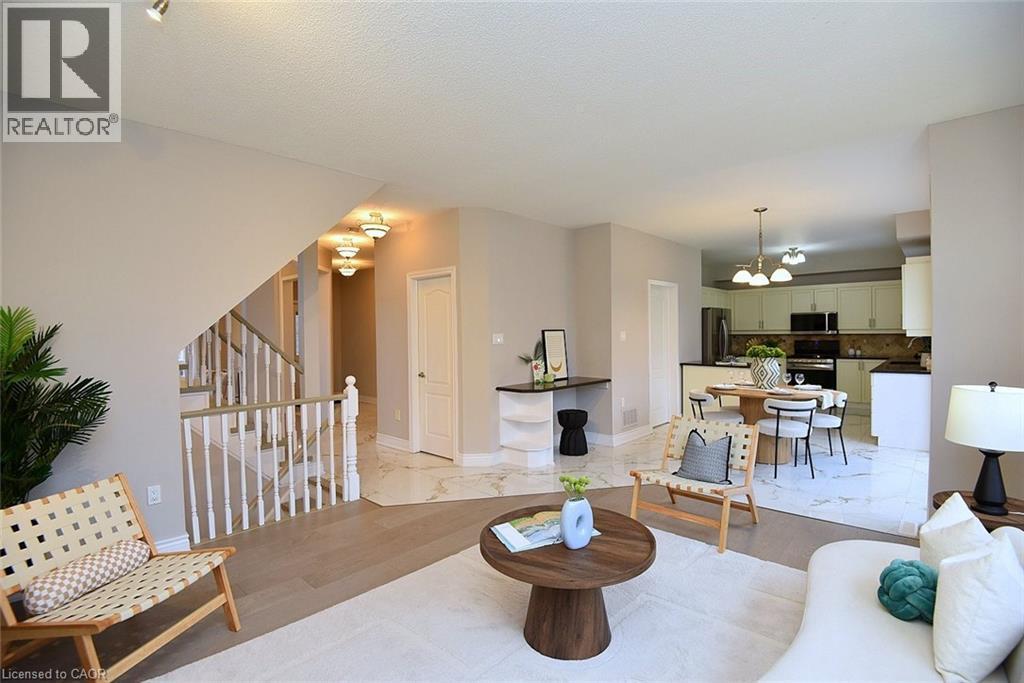 Living area featuring hanging lights and light wood-type flooring - 5109 Blue Spruce Avenue, Burlington, ON - Indoor Photo Showing Living Room
