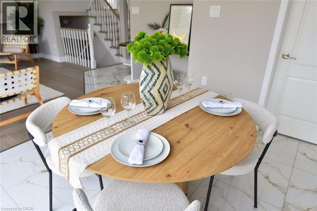 Dining room featuring stairs and light marble finish floors - 5109 Blue Spruce Avenue, Burlington, ON - Indoor