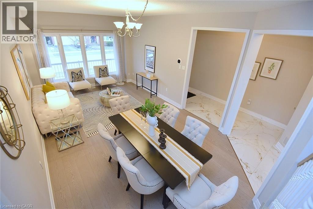 Dining area with a chandelier and light marble finish floors - 5109 Blue Spruce Avenue, Burlington, ON - Indoor