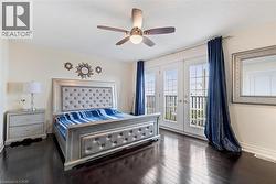 Bedroom with ceiling fan, dark hardwood / wood-style floors, access to outside, and french doors -
