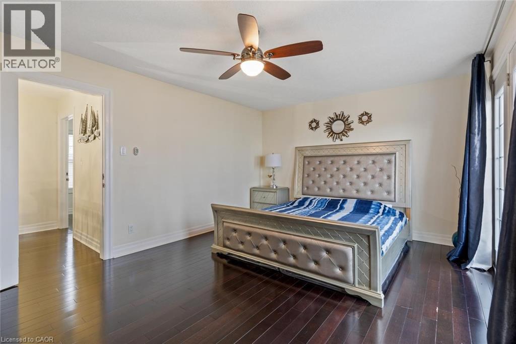 Bedroom featuring ceiling fan and dark hardwood / wood-style flooring - 1073 North Service Road, Hamilton, ON - Indoor Photo Showing Bedroom