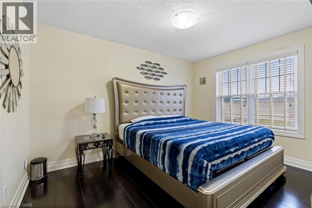 Bedroom featuring dark wood-type flooring and a textured ceiling - 1073 North Service Road, Hamilton, ON - Indoor Photo Showing Bedroom