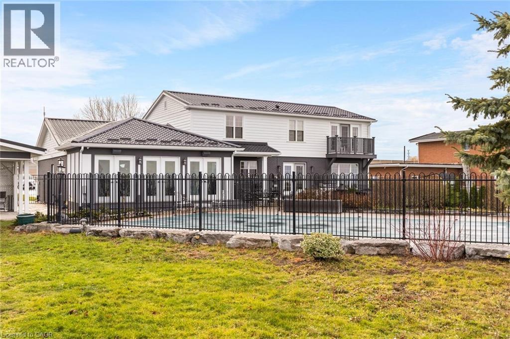 Back of property featuring a yard and a covered pool - 1073 North Service Road, Hamilton, ON - Outdoor