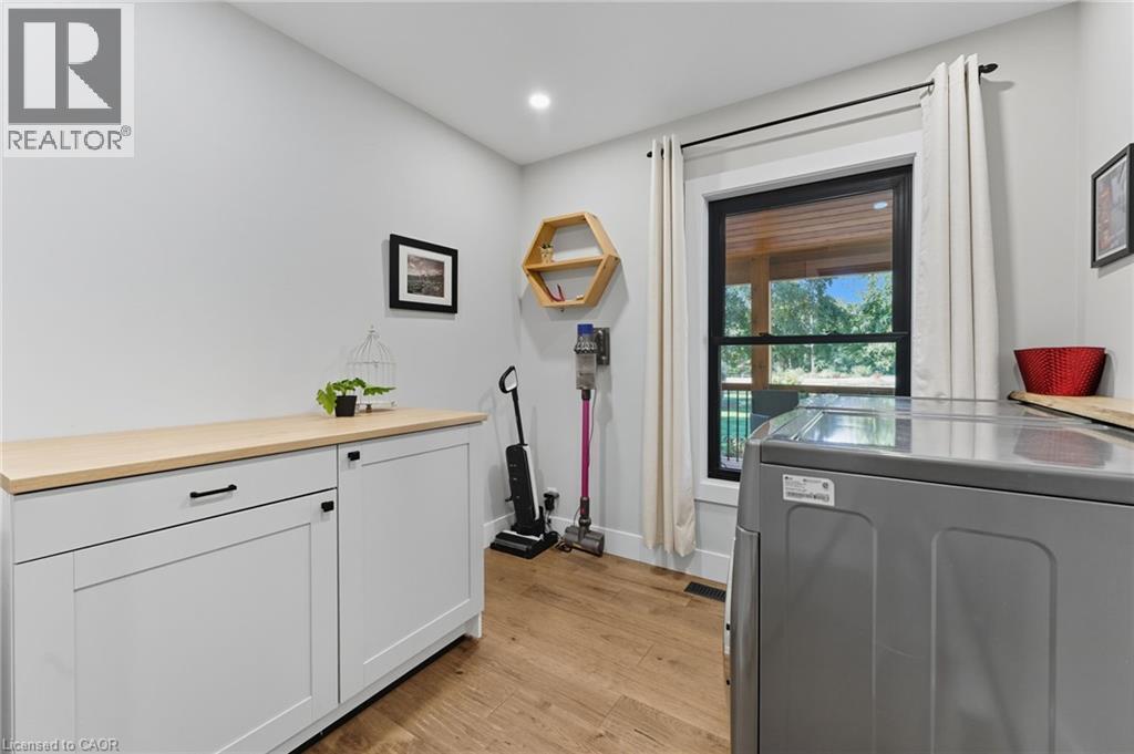 Washroom featuring washer / dryer, light wood-style floors, cabinet space, and recessed lighting - 115 Lakeshore Road, Port Burwell, ON - Indoor Photo Showing Other Room