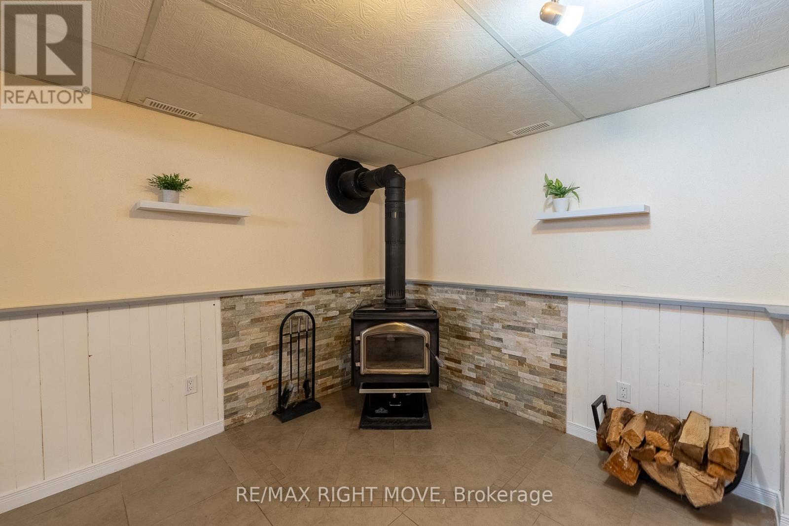 Cozy wood burning stove - 3304 Goldstein Road, Severn, ON - Indoor Photo Showing Other Room
