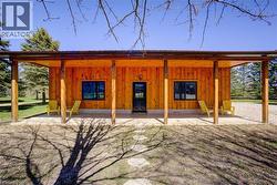 30’ x 40’ workshop is finished with pine shiplap, a 10’ x 9’ roll-up door, and a ceiling mounted forced air gas furnace and covered porch. -