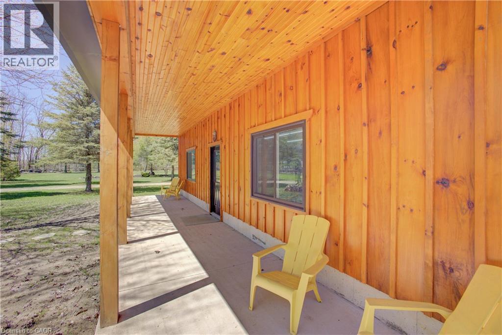 30’ x 40’ workshop is finished with pine shiplap, a 10’ x 9’ roll-up door, and a ceiling mounted forced air gas furnace and covered porch. - 802080 Grey Road 40, Chatsworth (Twp), ON - Photo Showing Other Room