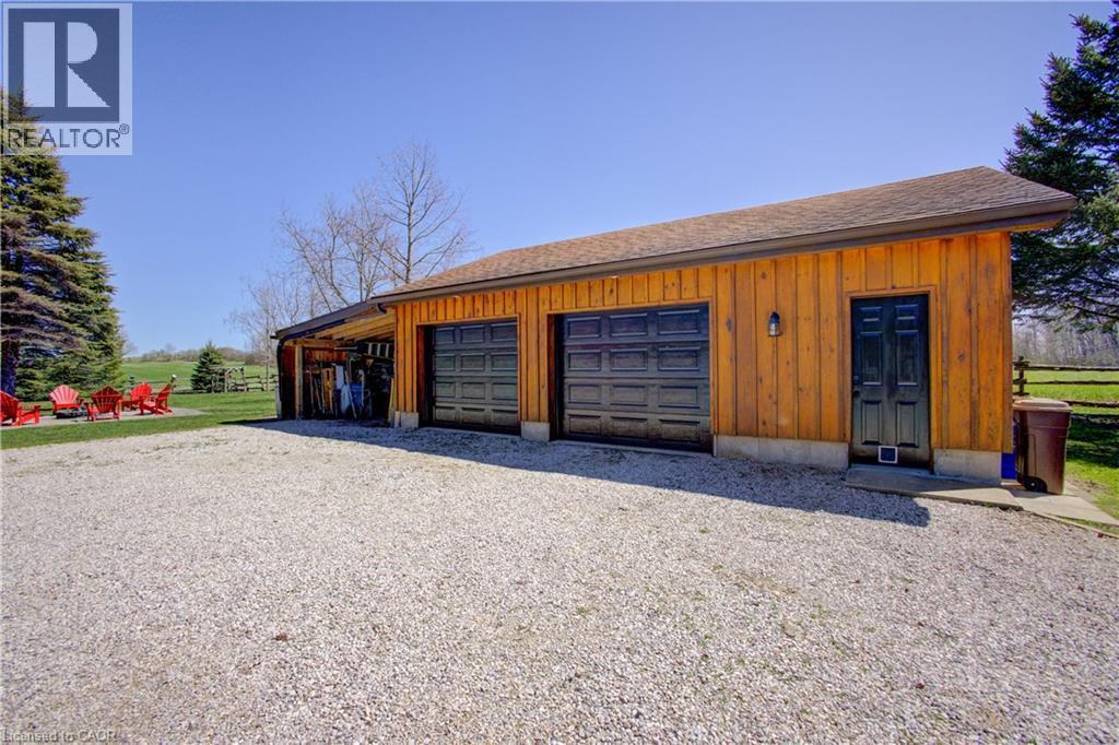 The 24’ x 30’ 2 car garage includes a wood stove and ample space for cars, and toys. A 24’ x 14’ lean-to adds even more room for storage - 802080 Grey Road 40, Chatsworth (Twp), ON - Outdoor