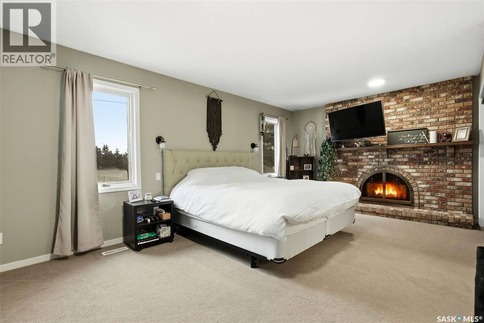 2402 Truesdale Drive, Regina, SK - Indoor Photo Showing Bedroom With Fireplace