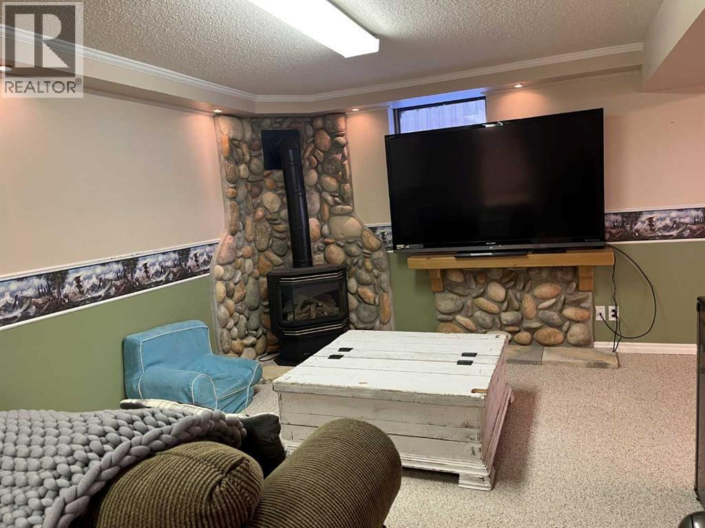 4617 51 Avenue, Taber, AB - Indoor Photo Showing Other Room With Fireplace