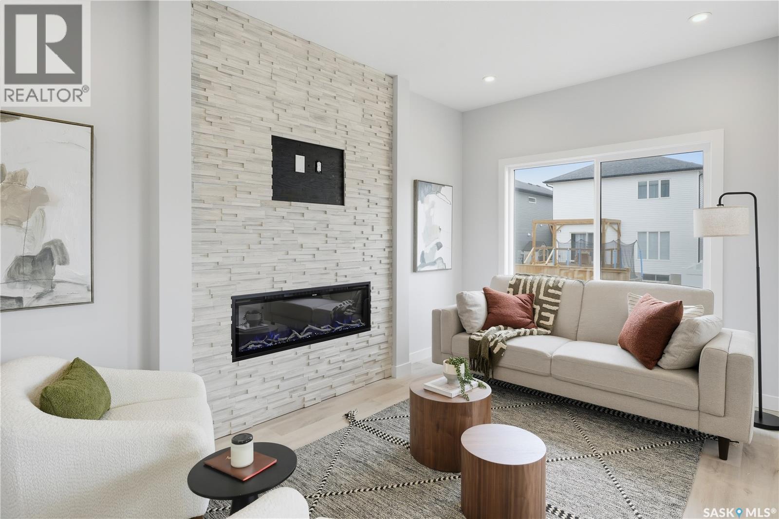 5545 Kennett Square, Regina, SK - Indoor Photo Showing Living Room With Fireplace