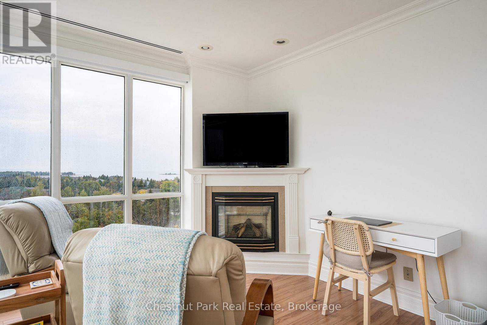 Gas fireplace and office area in primary bedroom - 1001 - 24 Ramblings Way, Collingwood, ON - Indoor Photo Showing Other Room With Fireplace
