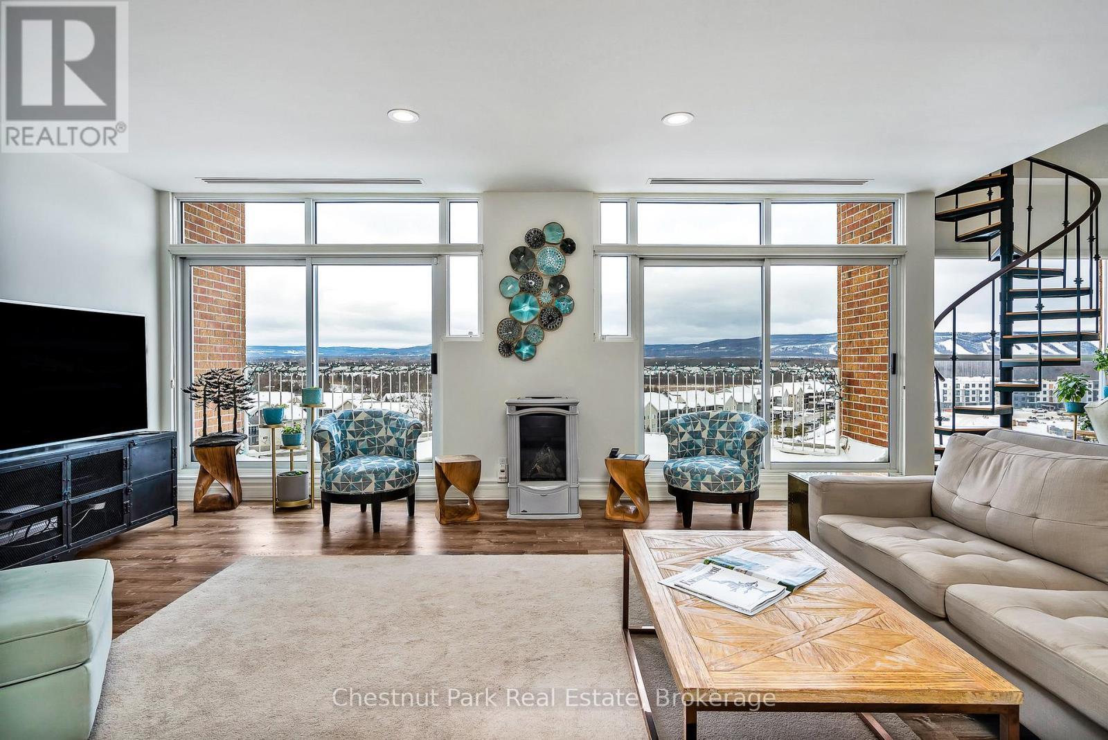 Cozy gas fireplace and views of the ski hills - 1001 - 24 Ramblings Way, Collingwood, ON - Indoor Photo Showing Living Room