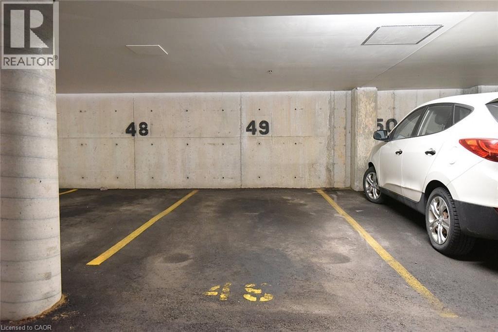 Owned spot in underground parking - 1411 Walkers Line Unit# 202, Burlington, ON - Indoor Photo Showing Garage
