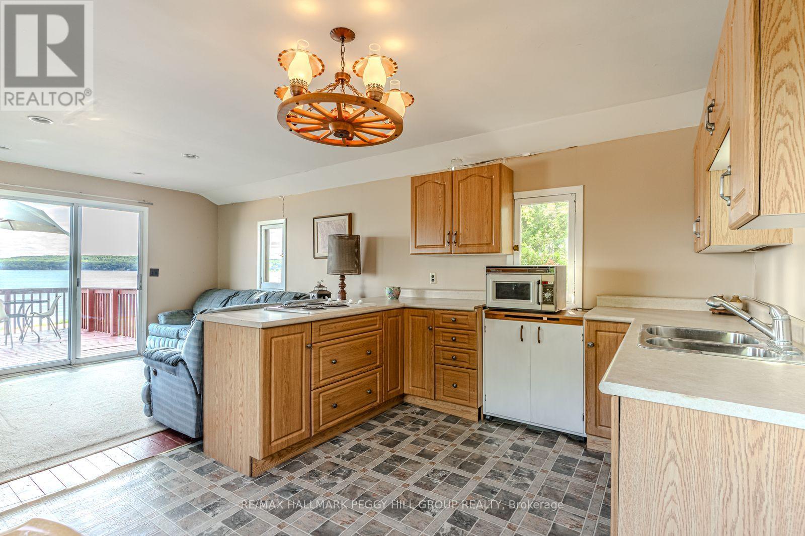 383 Peek-A-Boo Trail, Tiny, ON - Indoor Photo Showing Kitchen With Double Sink