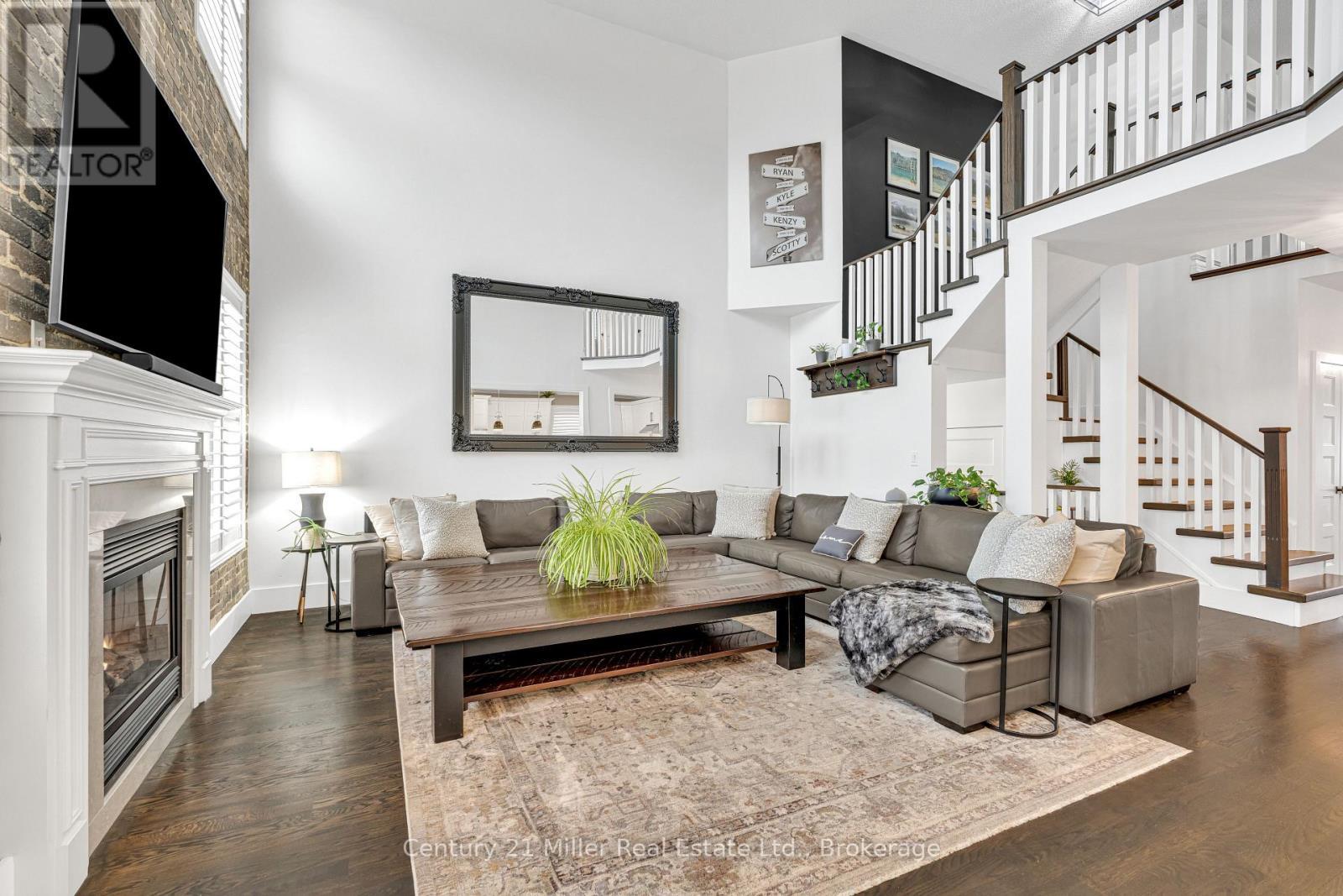 family - 2099 Helmsley Avenue, Oakville (Wm Westmount), ON - Indoor Photo Showing Living Room With Fireplace