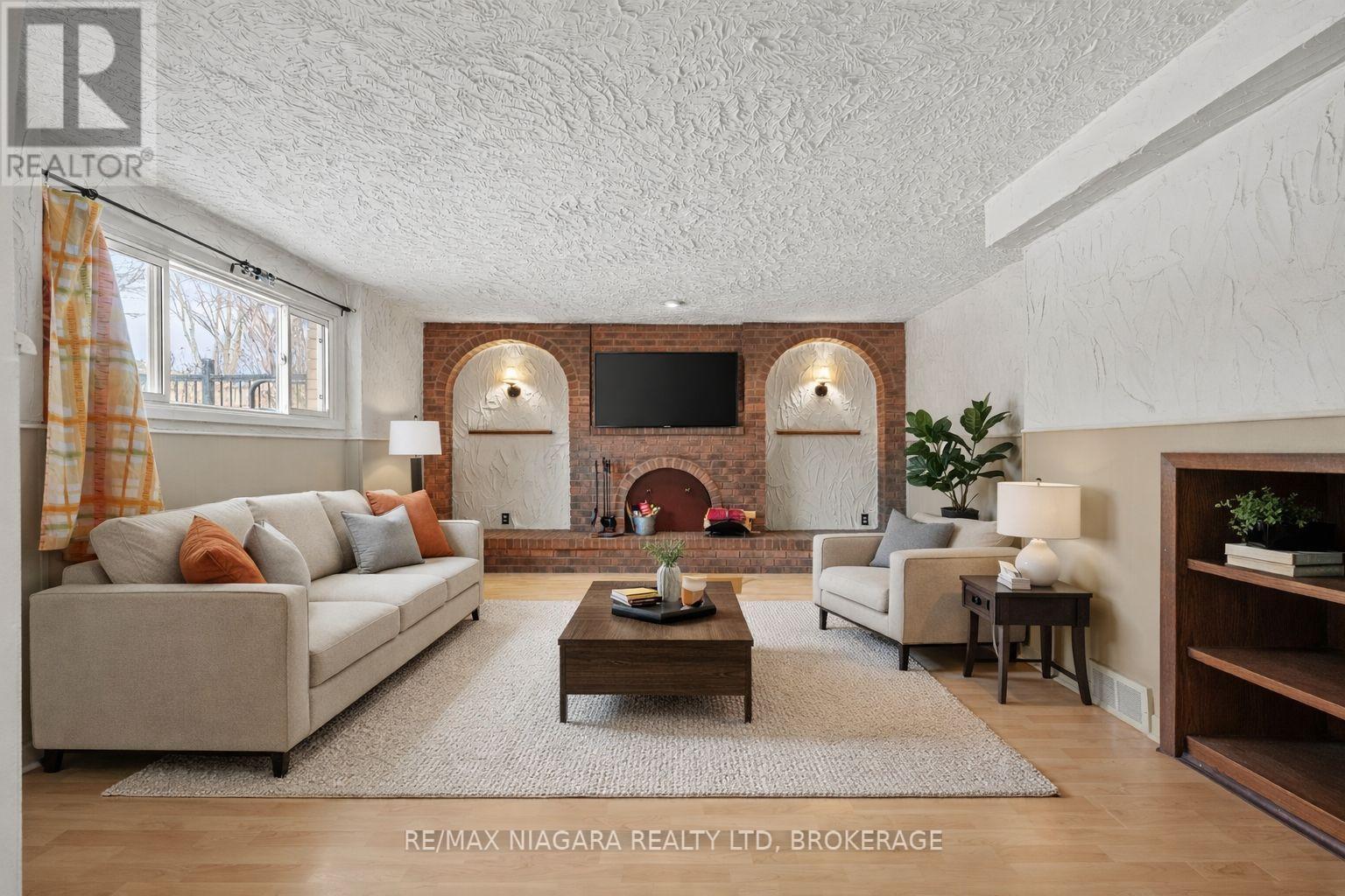 virtually staged - 12 Hampton Court, Welland (Prince Charles), ON - Indoor Photo Showing Living Room With Fireplace