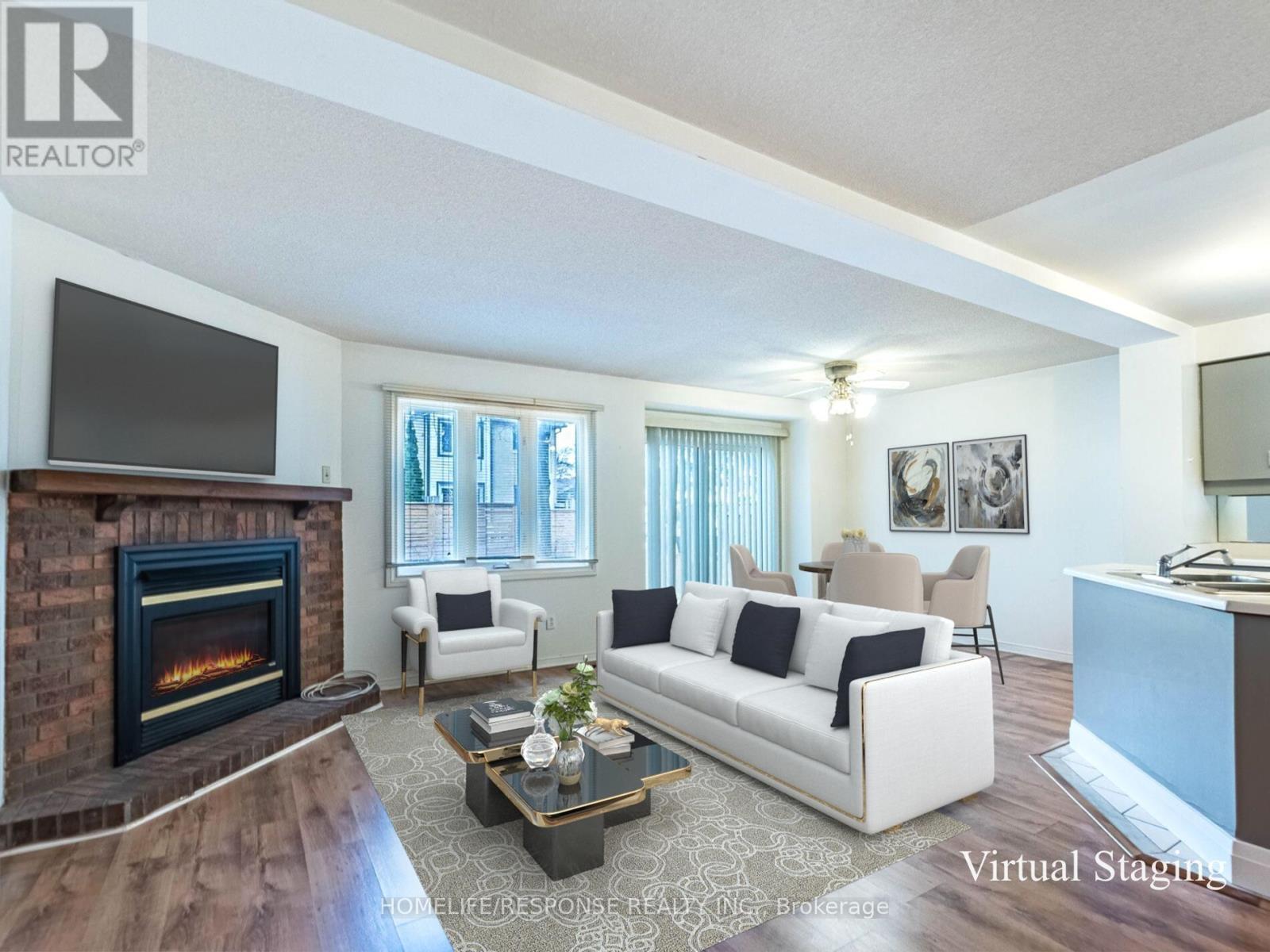 78 - 2275 Credit Valley Road, Mississauga, ON - Indoor Photo Showing Living Room With Fireplace