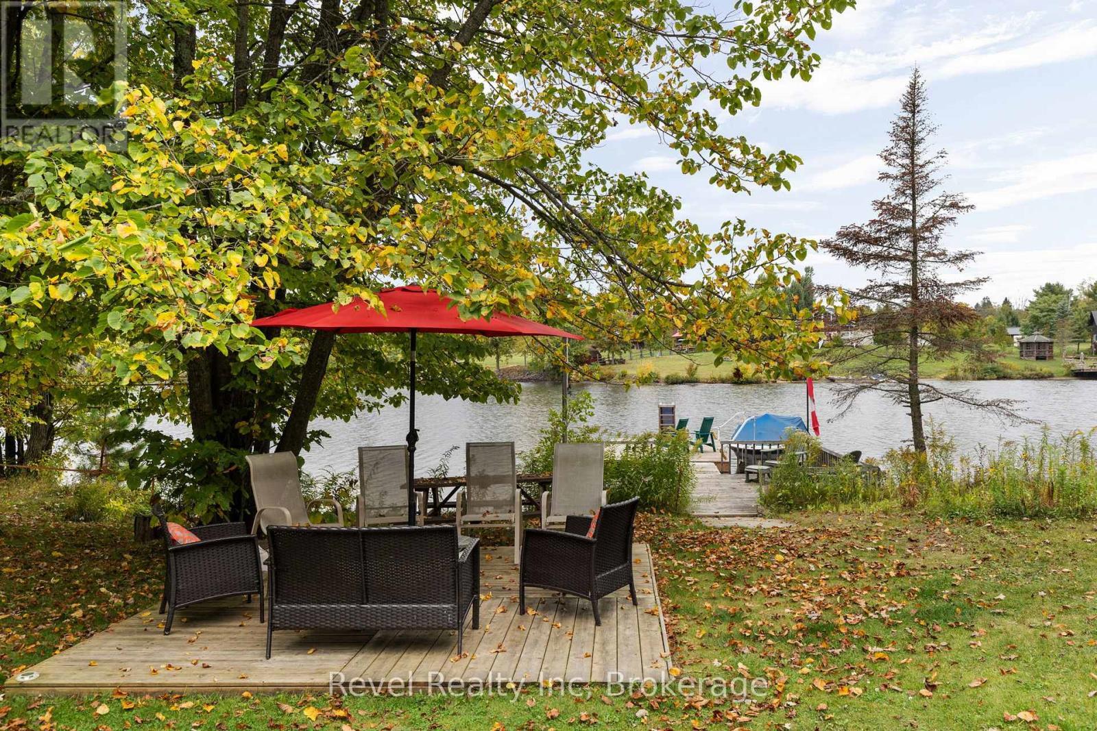 Sitting area and dock - 210 Burnett'S Road, Mckellar, ON - Outdoor With Body Of Water