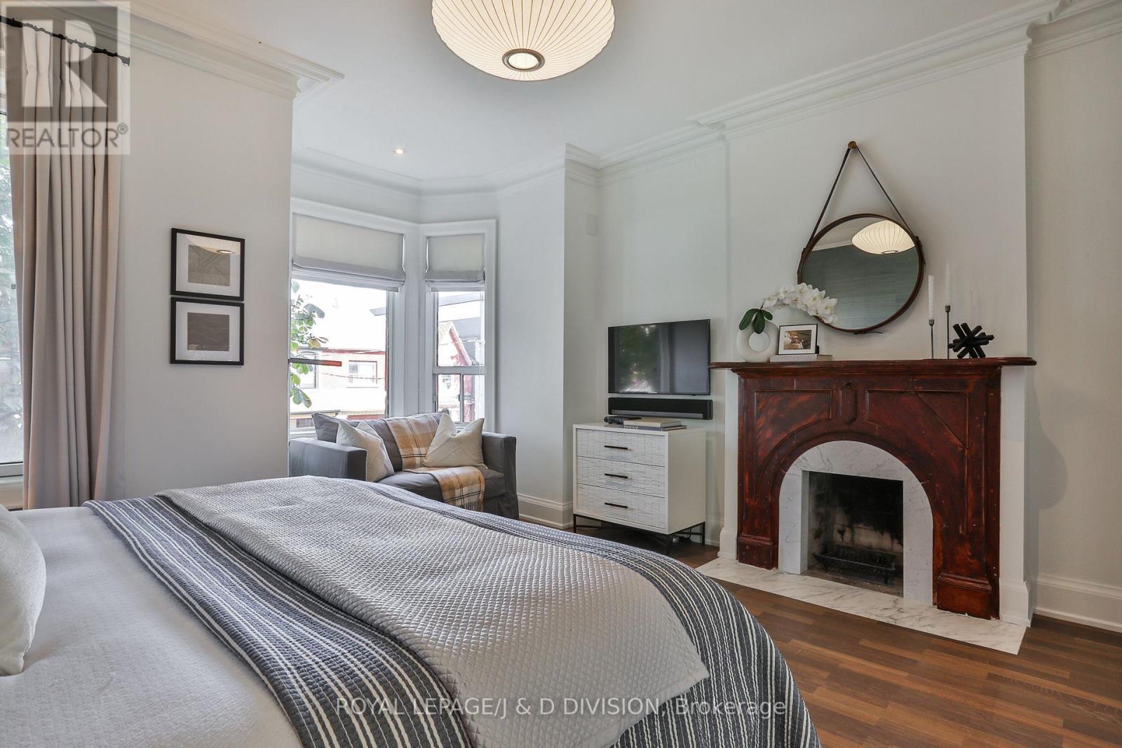 Bedroom #3 fireplace and bay window seating area - 69 Sullivan Street, Toronto, ON - Indoor Photo Showing Bedroom With Fireplace