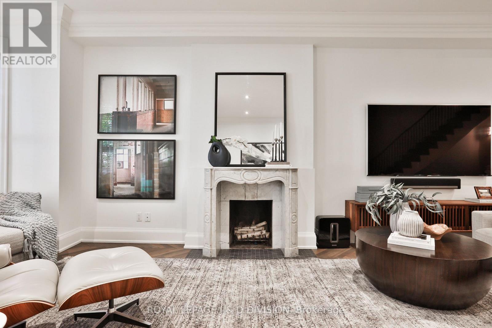 Two gorgeous marble fireplaces flank living space - 69 Sullivan Street, Toronto, ON - Indoor Photo Showing Living Room With Fireplace
