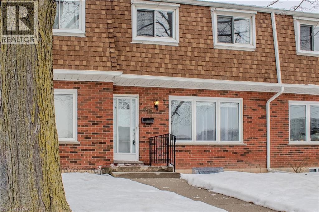 View of front of home featuring brick siding, mansard roof, and roof with shingles - 48 Riverdale Drive Unit# 2, Hamilton, ON - Outdoor With Exterior