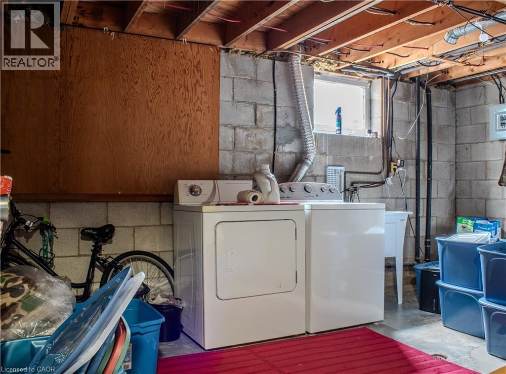 Laundry area featuring unfinished concrete floors and independent washer and dryer - 48 Riverdale Drive Unit# 2, Hamilton, ON - Indoor Photo Showing Laundry Room