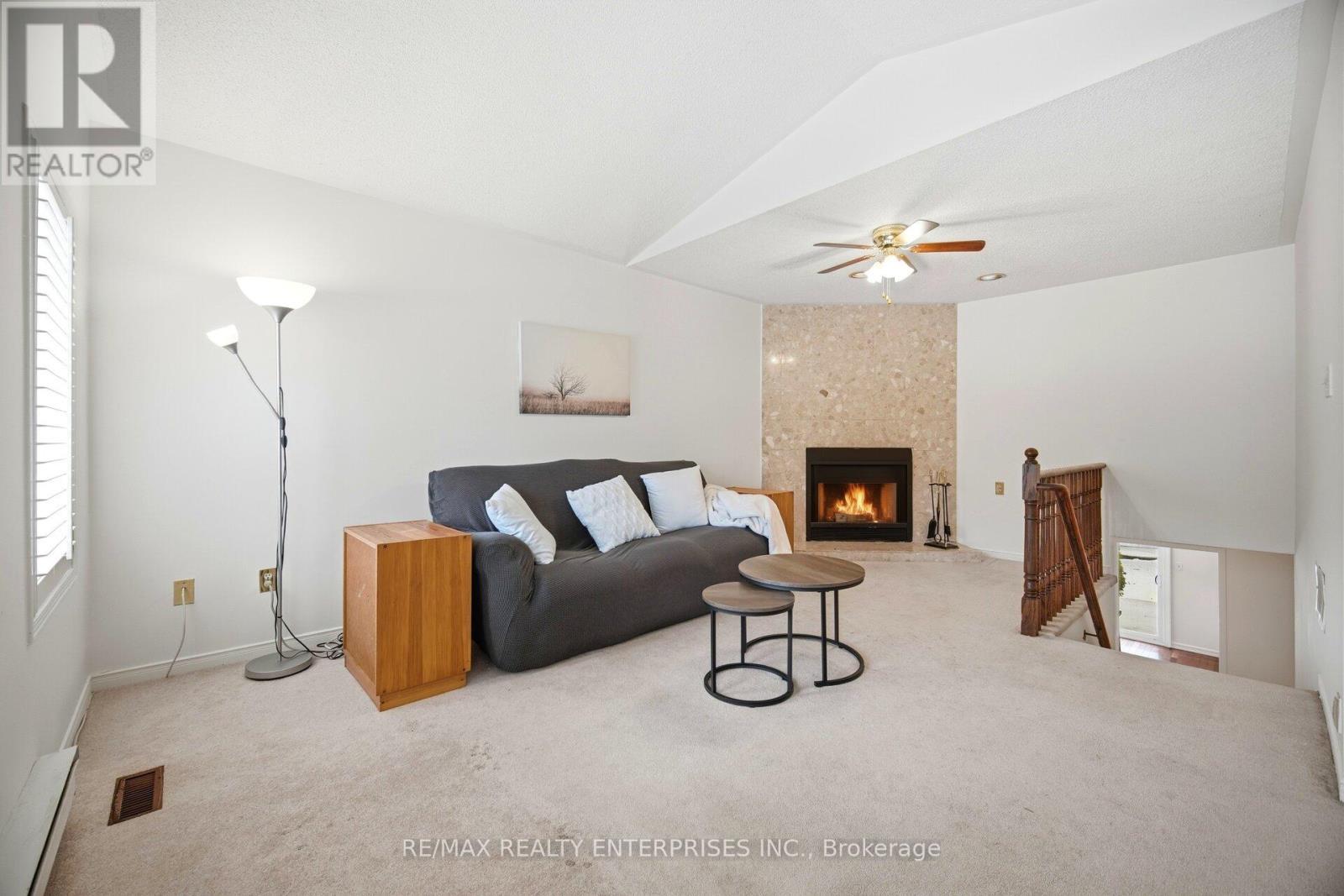 Family Room is large and bright - 1104 Feeley Court, Mississauga, ON - Indoor With Fireplace