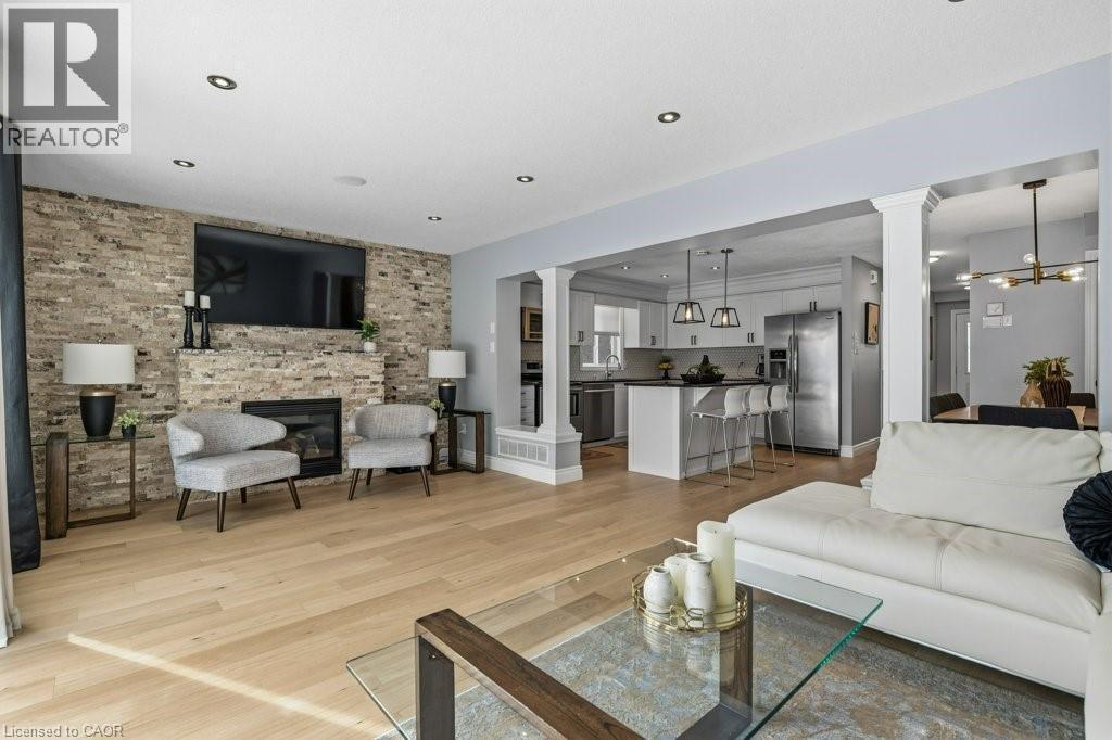 Tons of natural light and room for the whole family - 26 Helena Feasby Street, Kitchener, ON - Indoor Photo Showing Living Room With Fireplace