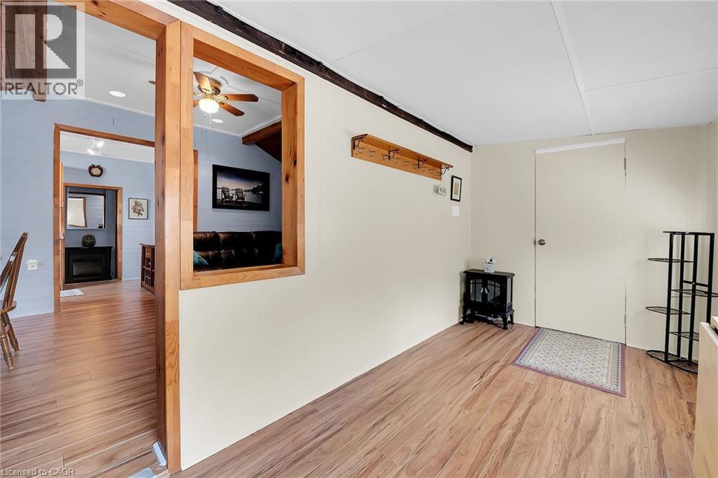 sunroom with electric fireplace and south facing windows - 17 Maple Lane, Rainham, ON - Indoor