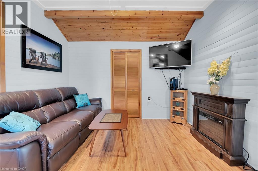 fans and electical lights included plus a 4 x 12 storage area off living room - 17 Maple Lane, Rainham, ON - Indoor Photo Showing Living Room With Fireplace