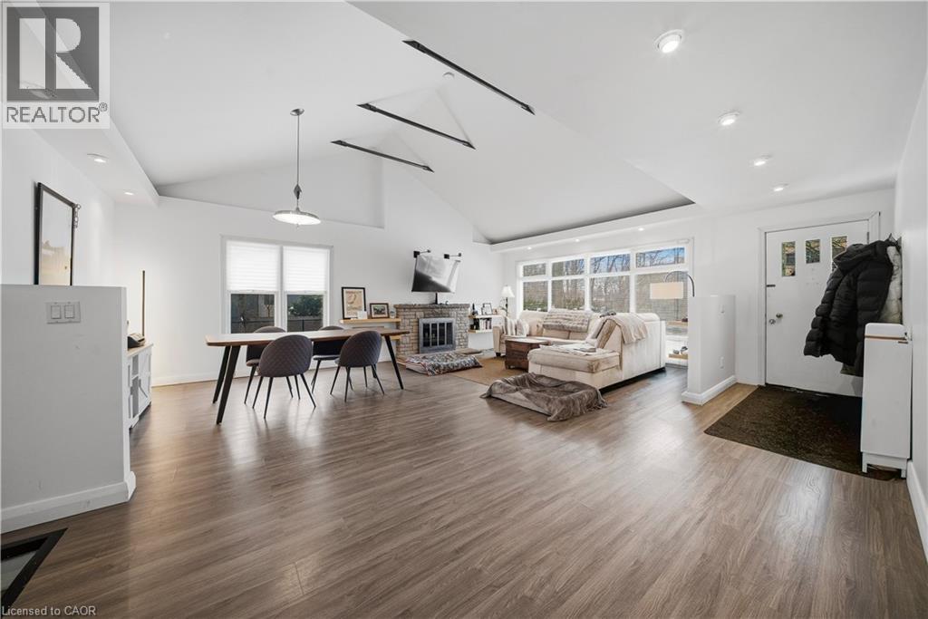 Living area featuring a brick fireplace, wood finished floors, recessed lighting, and high vaulted ceiling - 276 Lakeshore Road W, Oakville, ON - Indoor Photo Showing Living Room