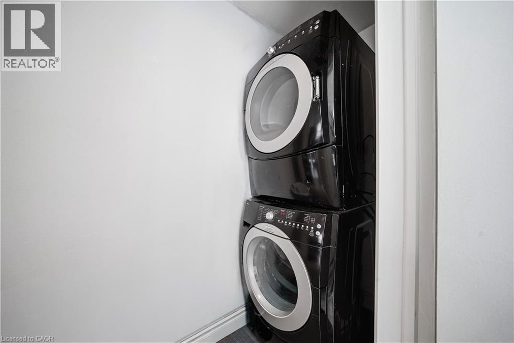 Laundry area with estacked washer and dryer - 276 Lakeshore Road W, Oakville, ON - Indoor Photo Showing Laundry Room