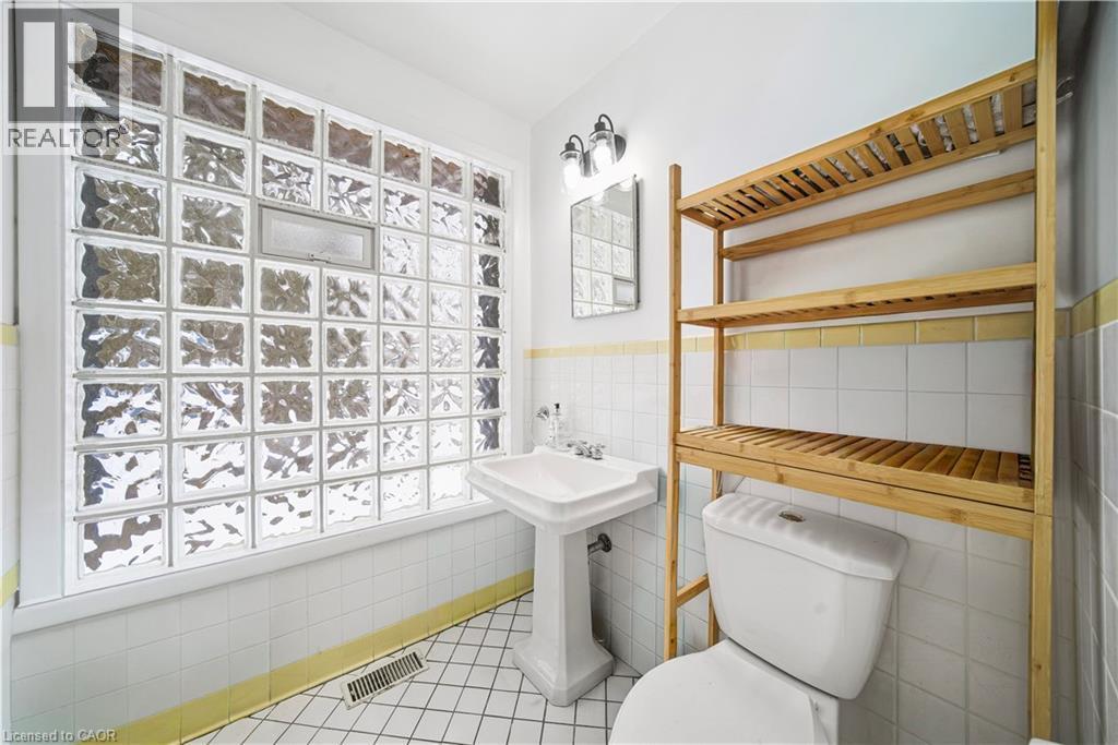 Bathroom with tile walls, a wainscoted wall, and light tile patterned floors - 276 Lakeshore Road W, Oakville, ON - Indoor