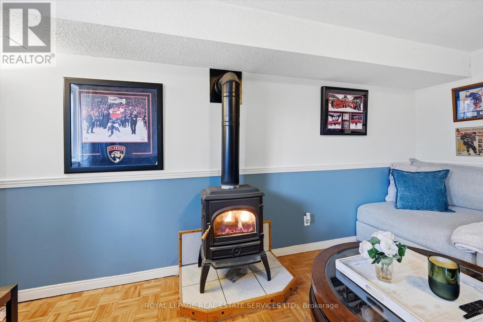 Generous Family Room Featuring a Cozy Gas Stove - 51 - 26 Moss Boulevard, Hamilton, ON - Indoor Photo Showing Living Room With Fireplace