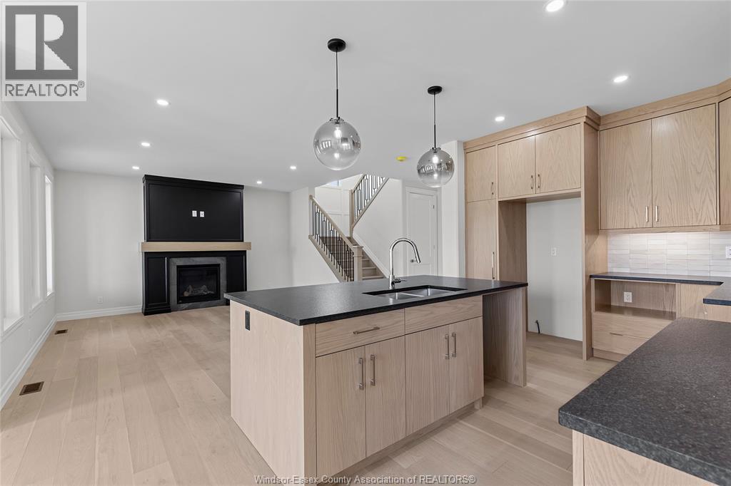 267 Joan Flood, Essex, ON - Indoor Photo Showing Kitchen With Fireplace With Double Sink
