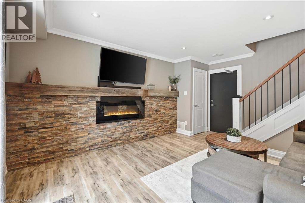 Fireplace ""flame"" is AI generated - 469 Claridge Road Unit# 6, Burlington, ON - Indoor Photo Showing Other Room With Fireplace