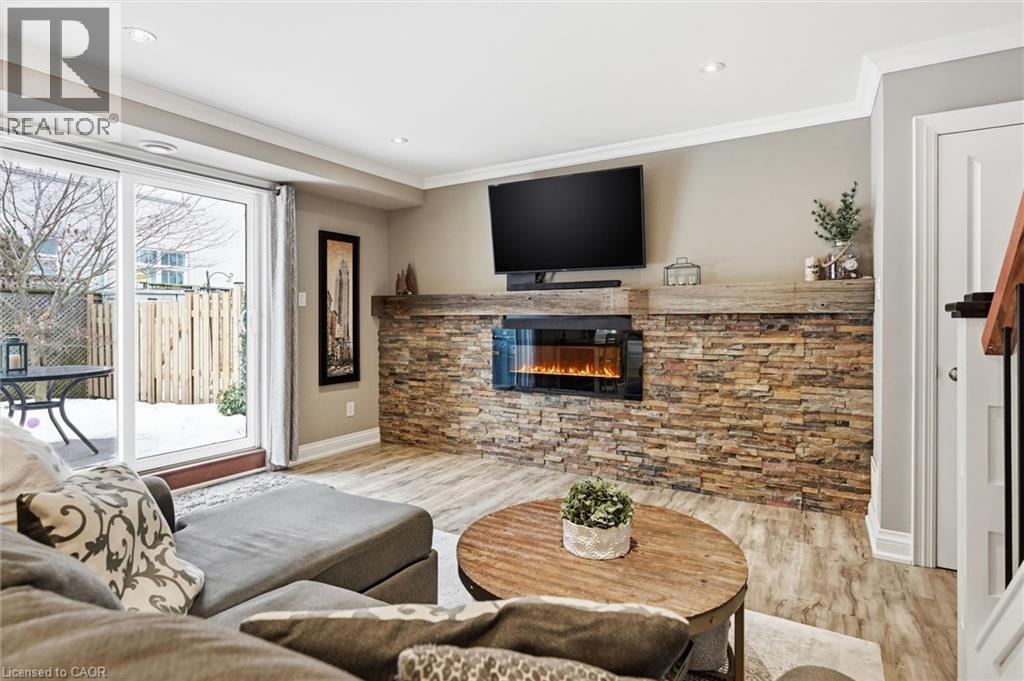 (fireplace flame is AI generated) - 469 Claridge Road Unit# 6, Burlington, ON - Indoor Photo Showing Living Room With Fireplace