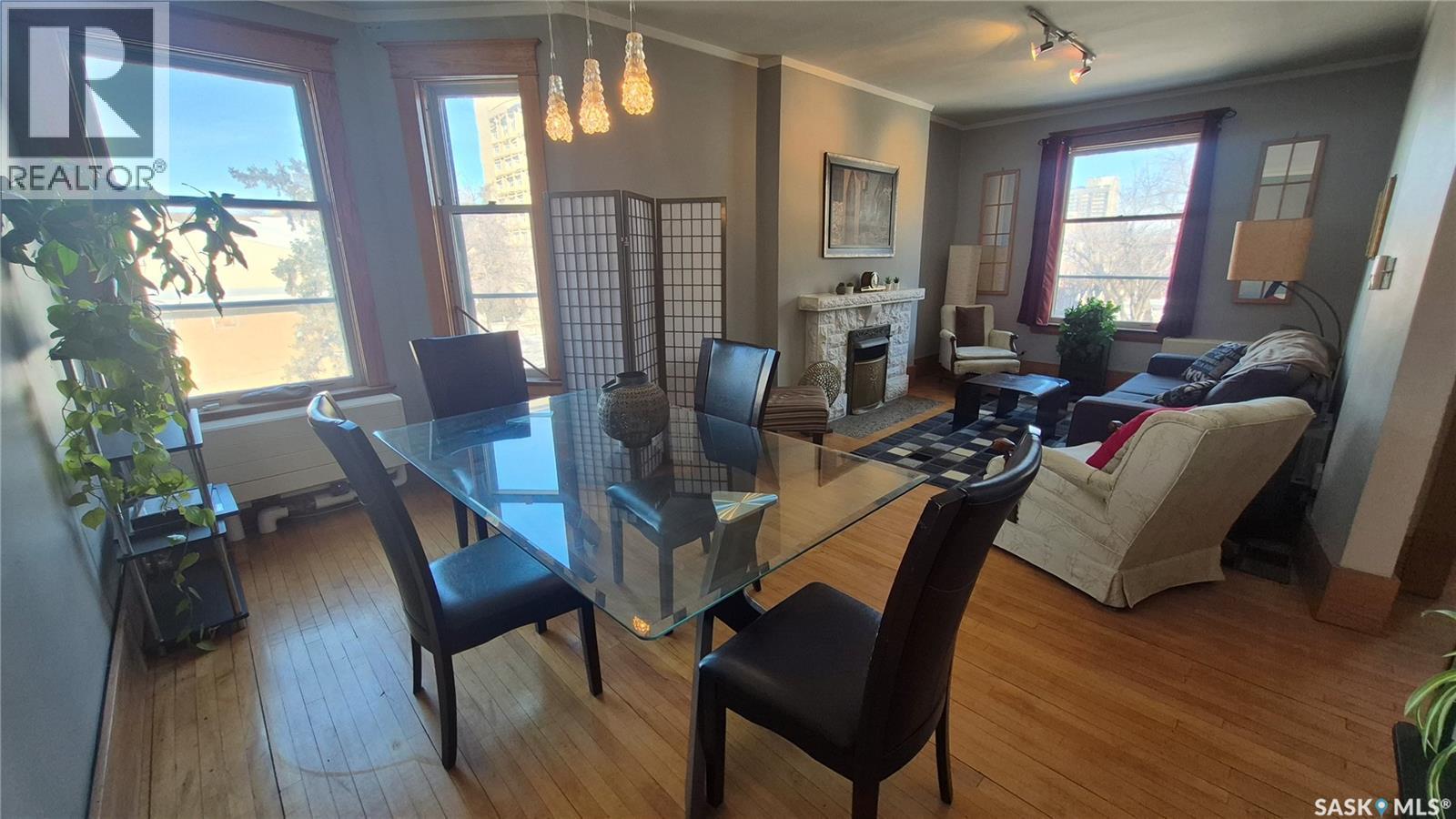 12 2201 14Th Avenue, Regina, SK - Indoor Photo Showing Dining Room With Fireplace