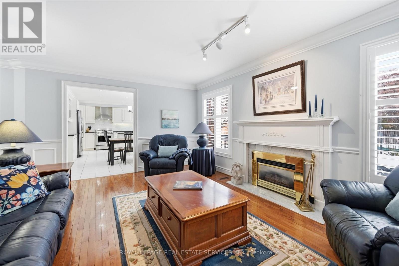 Comfortable Family Room with a Gas Fireplace - 2017 Peak Place, Oakville, ON - Indoor Photo Showing Living Room With Fireplace