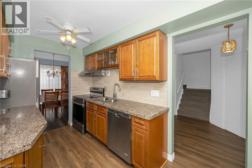 SS.appl. Dark wood-style flrs & stone countertops - 375 Kingscourt Drive Unit# 21, Waterloo, ON - Indoor Photo Showing Kitchen With Double Sink