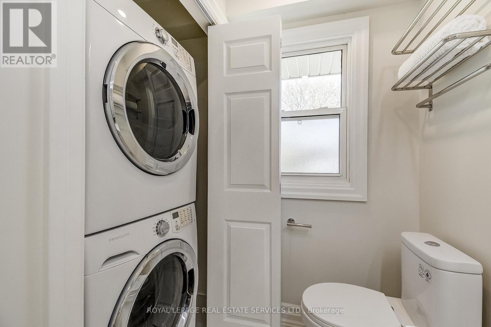 Stacked washer and dryer - 351 Strathcona Drive, Burlington, ON - Indoor Photo Showing Laundry Room
