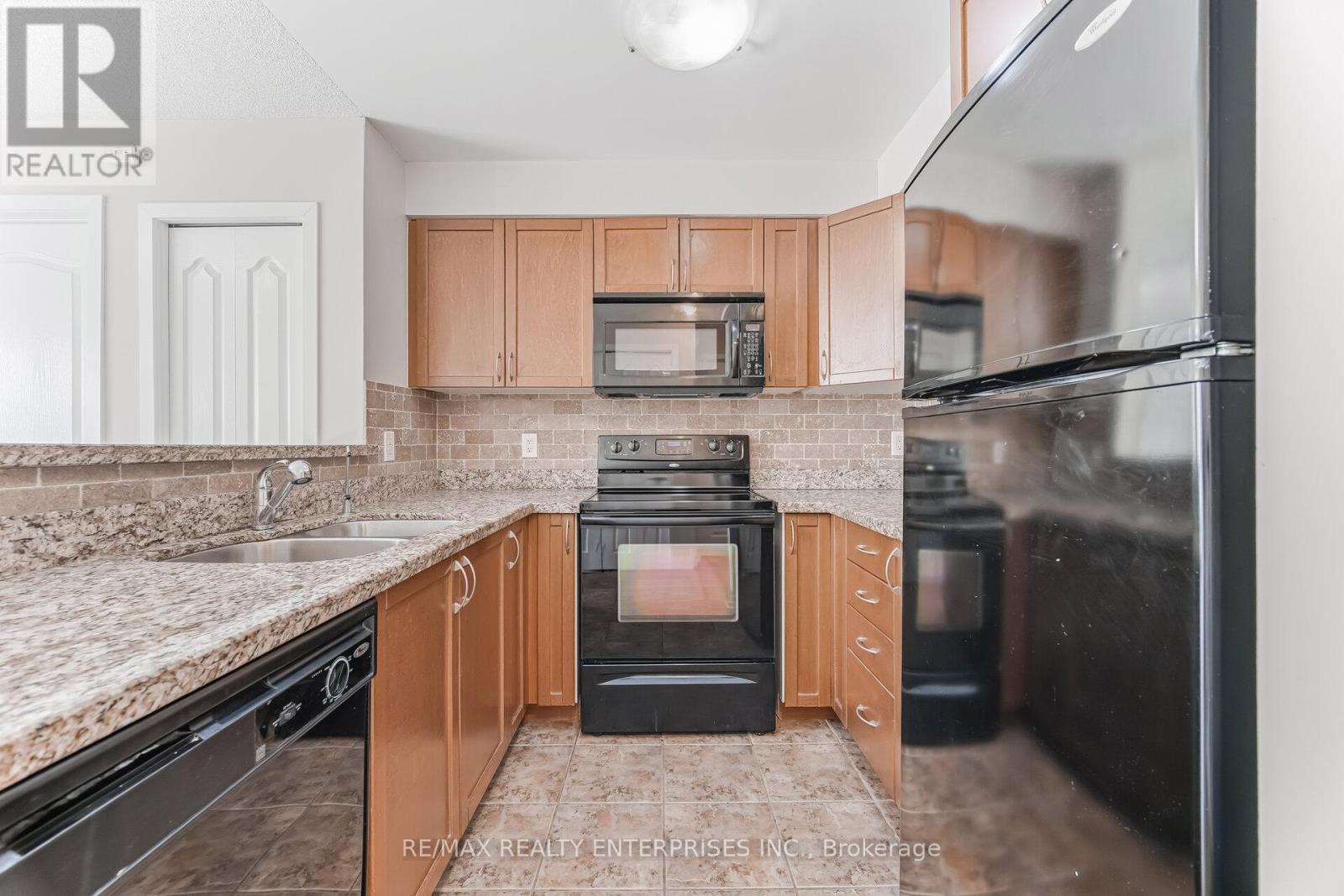 Kitchen with Ample Storage and Counter Space - 1420 - 8 Dayspring Circle, Brampton, ON - Indoor Photo Showing Kitchen With Double Sink