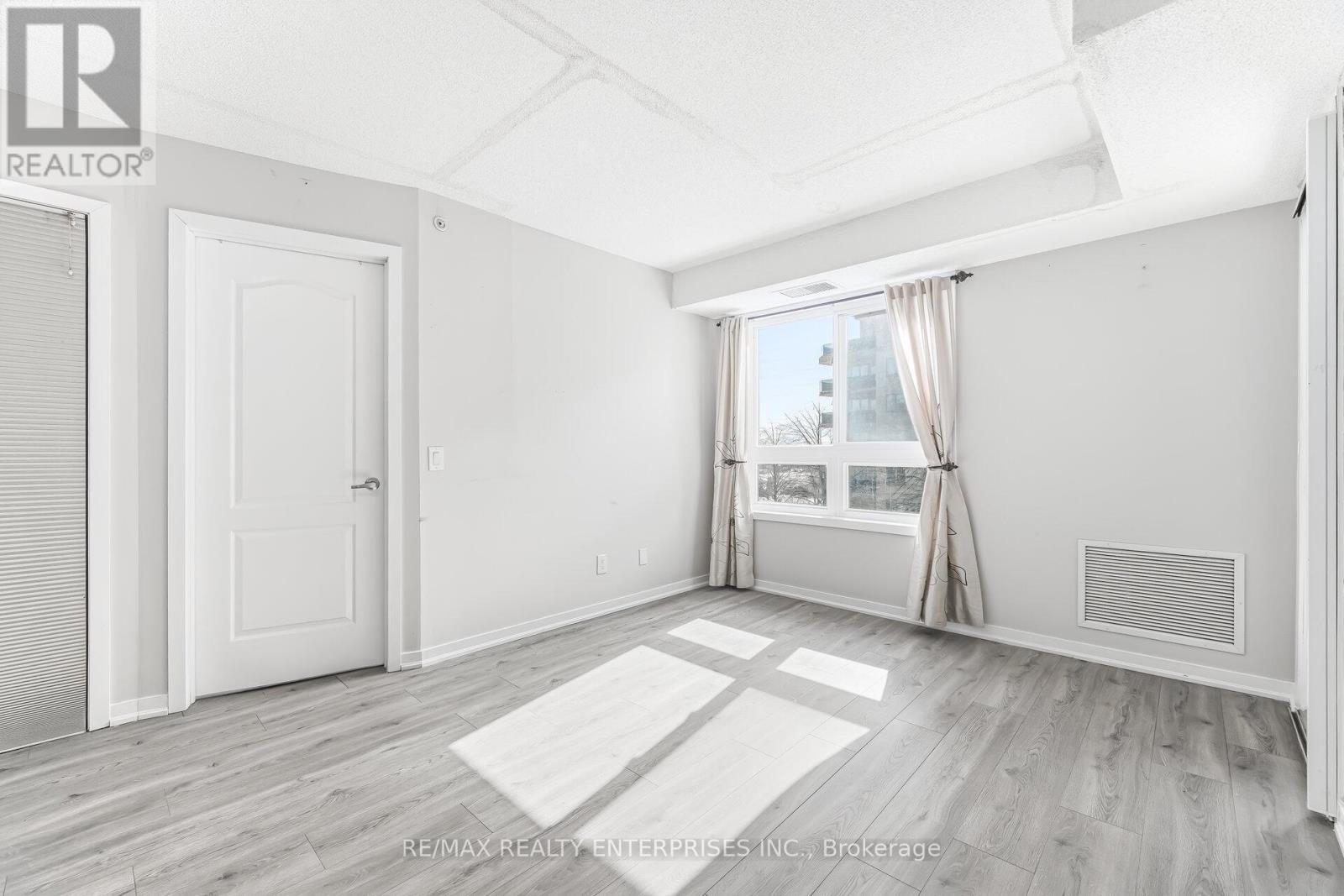 Large window creates a bright living space - 1420 - 8 Dayspring Circle, Brampton, ON - Indoor Photo Showing Other Room