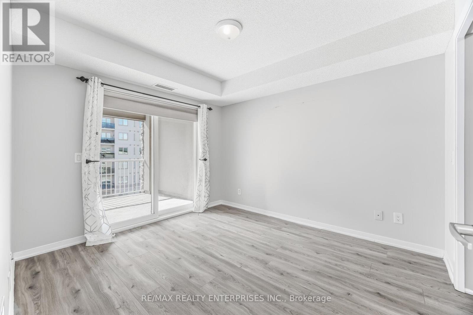 Primary Bedroom is large with walkout to balcony - 1420 - 8 Dayspring Circle, Brampton, ON - Indoor Photo Showing Other Room